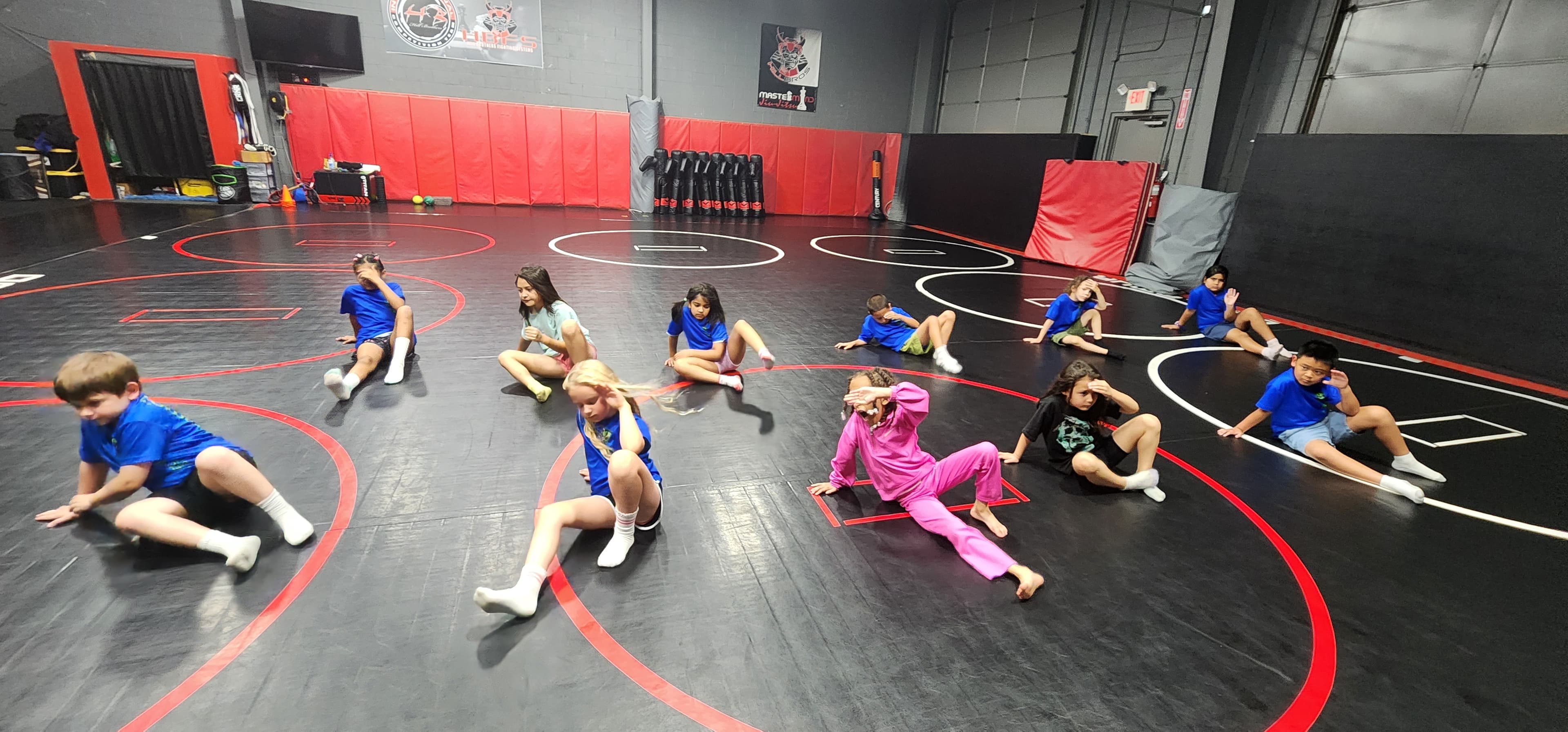 Plainfield's Best campers stretching together on martial arts mats